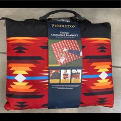 the pendleton bag is laying on the floor next to it's packaging and instructions