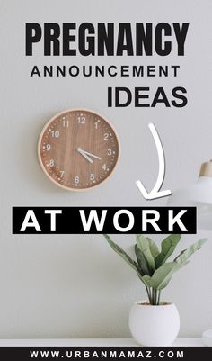 a clock sitting on top of a table next to a plant