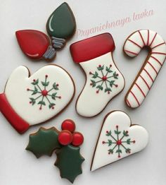 decorated christmas cookies arranged on top of each other with holly, stockings and candy canes