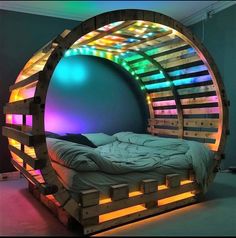 a bed made out of wooden pallets with colorful lights