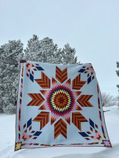 a large quilt is hanging in the snow