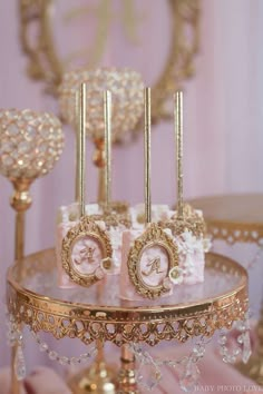 there is a cake that has been decorated with pink and gold decorations on top of it