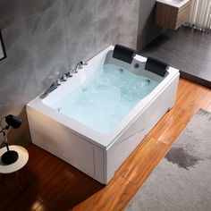 a bath tub sitting on top of a wooden floor