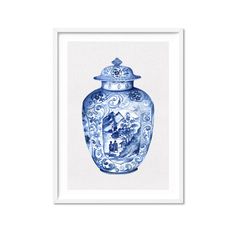 a blue and white vase with a house on it is framed in a white frame