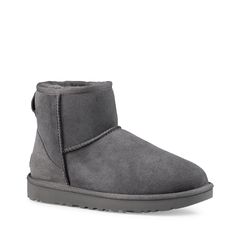 These women's UGG Classic Mini II grey boot is designed to keep you warm and on-trend, without the heavy weight. Made with soft sheepskin upper, these cold weather booties have a round toe front, easy slip-on design, Post-Applied Treatment Treated to repel light amounts of water, rear pull tabe, soft sheepskin lining, polyester binding, suede heel counter with embossed UGG logo heel label, and a durable Treadlite by UGG lightweight outsole. | Ugg Women's Classic Mini II Boot in Grey Suede Size 9 Vs Outfits, Ugg Mini Bailey Bow, Ugg Classic Mini Ii, Ugg Boots Outfit, Ugg Boots Tall, Classic Ugg Boots, Ugg Classic Mini, Women's Cover Ups, Shearling Boots