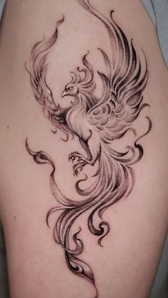 a woman's thigh with a bird tattoo on it