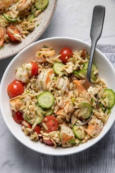 two bowls filled with rice and vegetables on top of a table