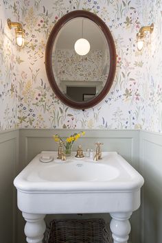 a white sink sitting under a mirror in a bathroom