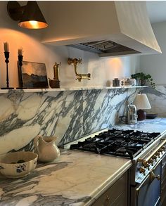 a kitchen with marble counter tops and an oven