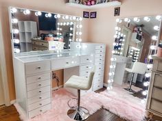 a vanity with lights and stool in front of it