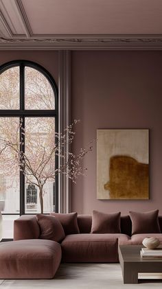 an elegant living room with pink walls and furniture