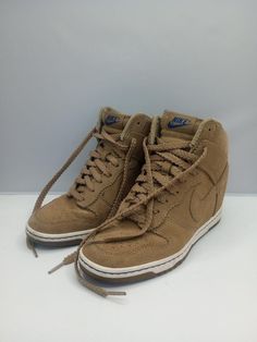 THESE SHOES ARE IN VERY GOOD CONDITION. Elevate your sneaker game with these Nike Dunk Sky High sneakers. Featuring a beige suede upper with hidden wedge heel, these shoes are perfect for casual occasions or walking activities. The lace-up closure and standard shoe width ensure a comfortable fit, while the rubber outsole and foam insole provide cushioned support. These sneakers are part of the Nike Dunk product line and have a style code of 528899-201. They were manufactured in China in 2012 and are available in US shoe size 7.5 and UK shoe size 5. The shoes also have accents of Nike logo and a solid pattern. Get ready to rock these athleisure sneakers in summer, fall, or spring. Nike Sky High Wedge, Walking Activities, Hidden Wedge Sneakers, Athleisure Sneakers, High Sneakers, Sneakers Athletic, Sneaker Games, Wedge Sneakers, Sky High