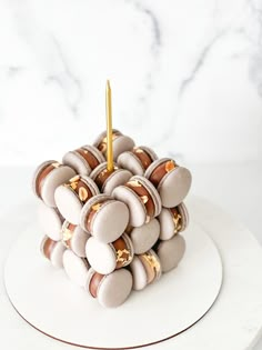 a white plate topped with lots of donuts on top of a marble countertop