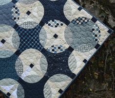 a blue and white quilt with circles on it