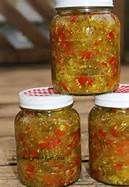 three jars filled with yellow and red confetti sitting on top of a wooden table