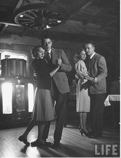 an old black and white photo of people dancing