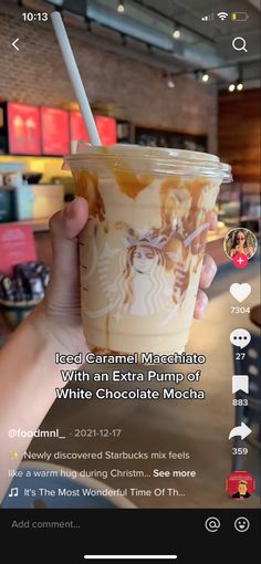 someone holding up a cup of coffee in front of a screen with the text iced caramel macchiato