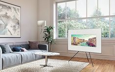 a living room with a couch, coffee table and large painting hanging on the wall