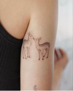 a sweet tattoo of two deer kissing on the back of the arm fine line style Buck And Fawn Tattoo, Fineline Deer Tattoo, Deer And Fawn Tattoo, Sleeping Deer Tattoo, Dainty Deer Tattoo, Doe And Fawn Tattoo