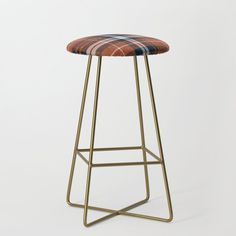 an upholstered bar stool with a plaid seat cover on the backrest and gold frame