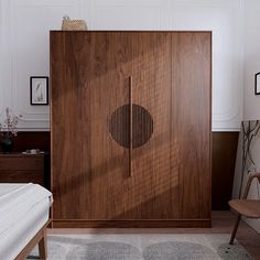 a room with a bed and a wooden cabinet