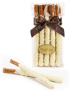 white chocolate dipped pretzels wrapped in cellophane and tied with brown ribbon