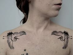 a woman with two birds on her chest and stars around her neck, looking to the side