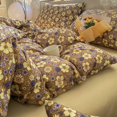 a bed covered in brown and blue flowers