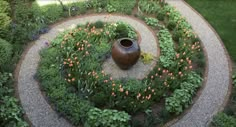 a circular garden with flowers and plants around it