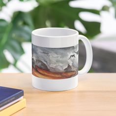 a white coffee mug sitting on top of a wooden table