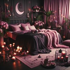 a bedroom with candles and flowers on the floor next to a bed covered in pink blankets