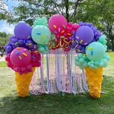 an ice cream cone filled with balloons and streamers