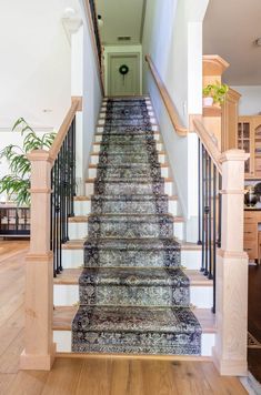 a staircase with carpeted steps leading up to an open door