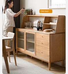 a woman standing in front of a wooden cabinet