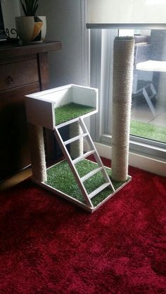 a cat tree that is in the corner of a room with a ladder on it