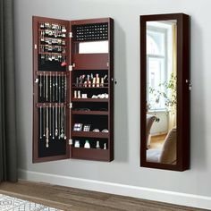 a mirror and jewelry cabinet in a room