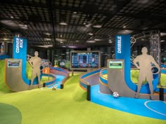 an indoor trampoline park with people playing on the ground and in the background