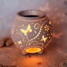 a lit up vase with butterflies on it