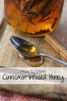 a jar filled with cinnamon infused honey next to a spoon