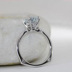 a close up view of a diamond ring on a rock