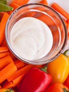 carrots, bell peppers and dip in a glass bowl