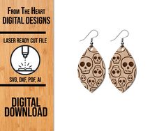 a pair of wooden earrings with skulls on them and the text from the heart digital designs laser ready cut file