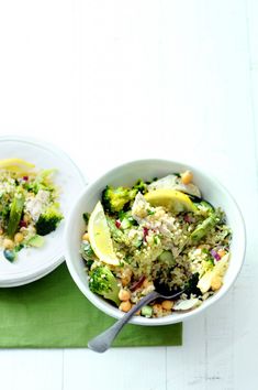 two white bowls filled with food on top of a green place mat