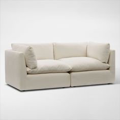 Pillowy soft with a modern style. The Lola 2-Piece Sofa elevates your space with minimalist detailing, cloud-like comfort and oversized seating you just want to burrow in. | Lola 2-Piece Sofa in Ivory | by Value City Furniture Large White Sofa, Large White Couch, White Sofa Living Room Modern, White Sofa Living Room, White Sofa, White Couches, American Signature Furniture, Value City Furniture, White Sofas