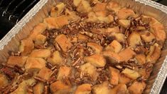 a pan filled with bread and nuts on top of a stove