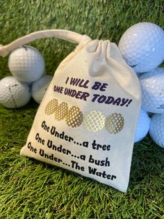 golf balls in a bag sitting on the grass