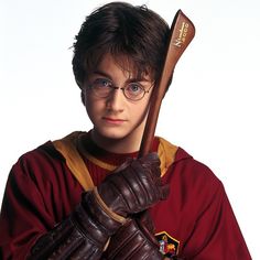 a young man dressed as harry potter holding a baseball bat and wearing gloves with both hands