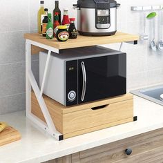 a microwave sitting on top of a wooden shelf