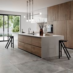 a modern kitchen with wooden cabinets and white counter tops