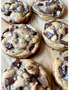 several chocolate chip cookies on a piece of parchment paper